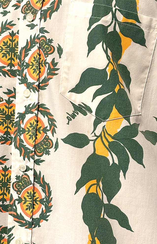 a closeup of a pattern on a piece of fabric, leaves and lemon