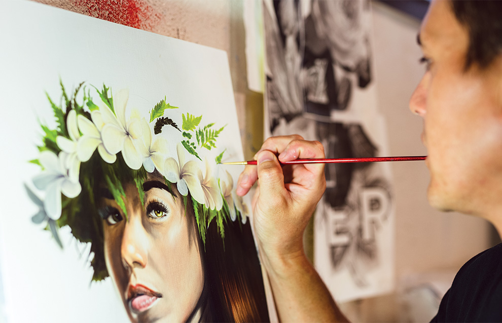 A man paints a portrait of a woman