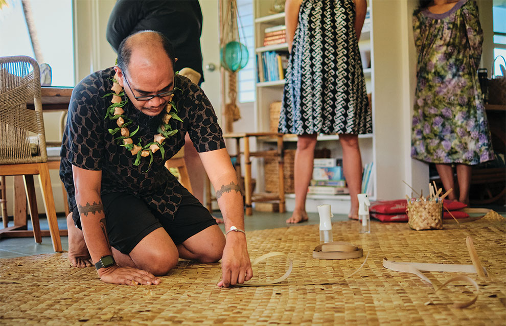 person working on a bamboo mat