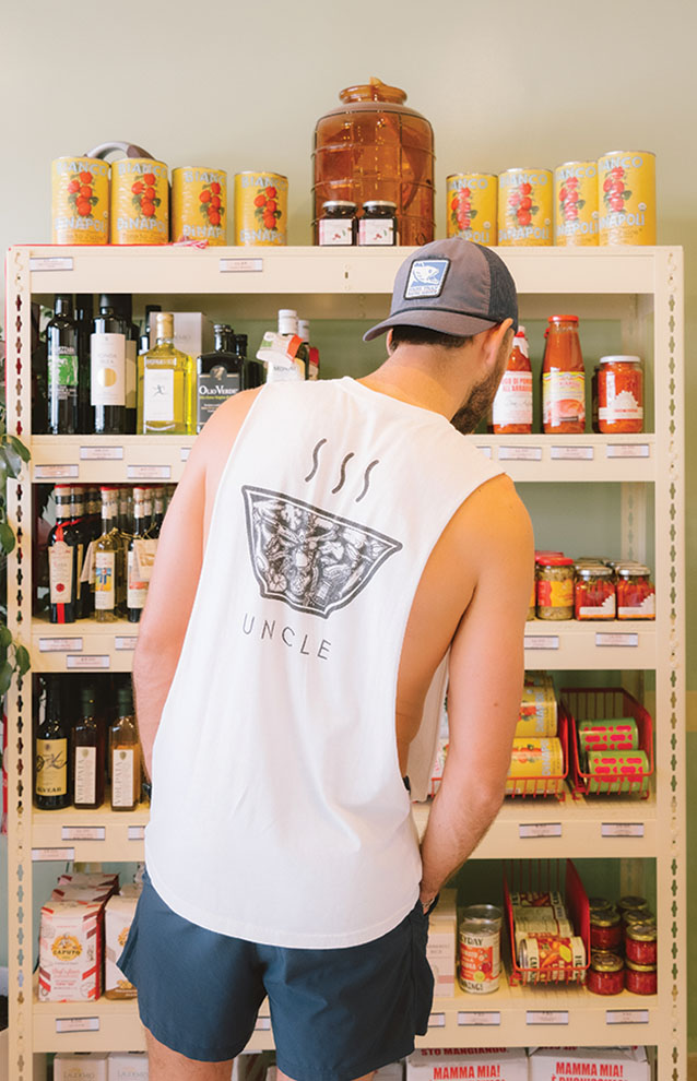 a person browsing inside of a small grocery store