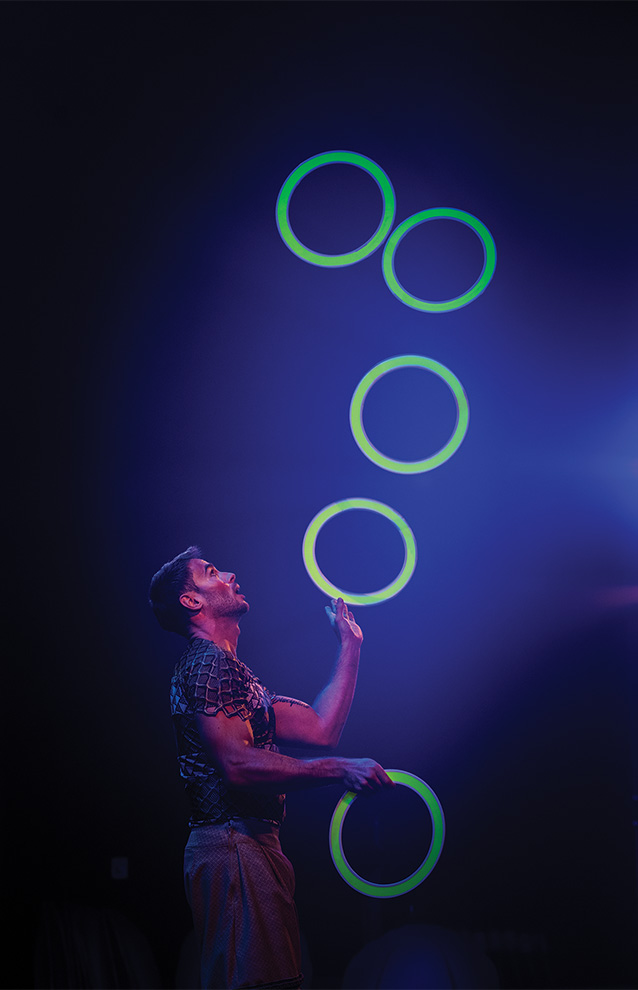 a person juggling glowing rings