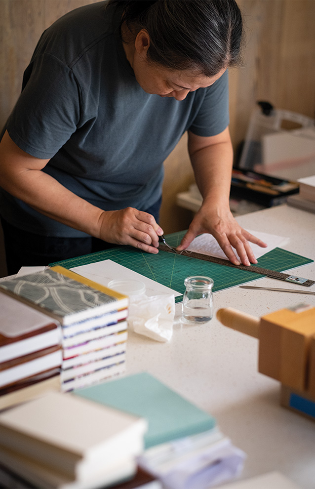 person working on crafts onto a table