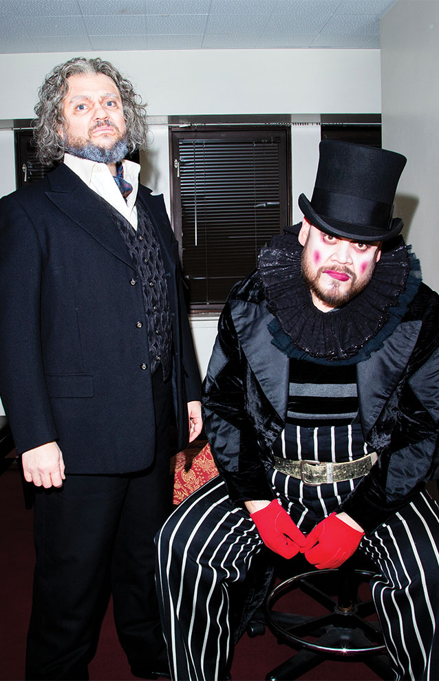 two people dressing in suit costumes with red gloves