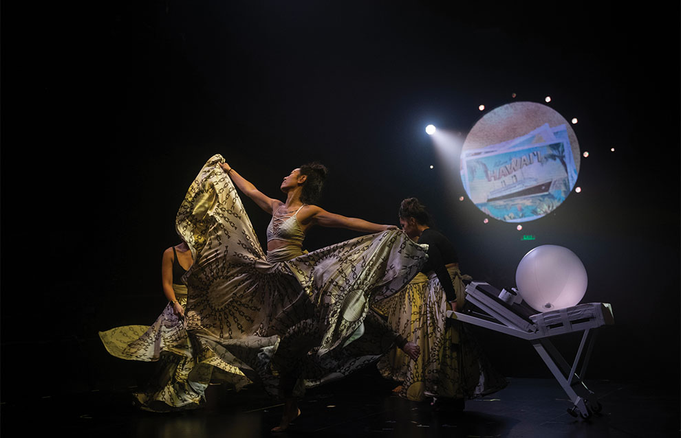 a person performing with lots of patterned fabric